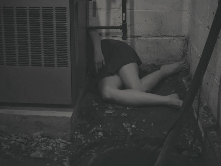 a woman lying down in a brick room