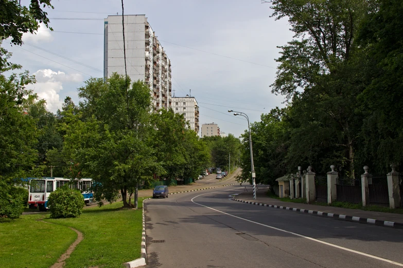 a long stretch of road in front of tall buildings