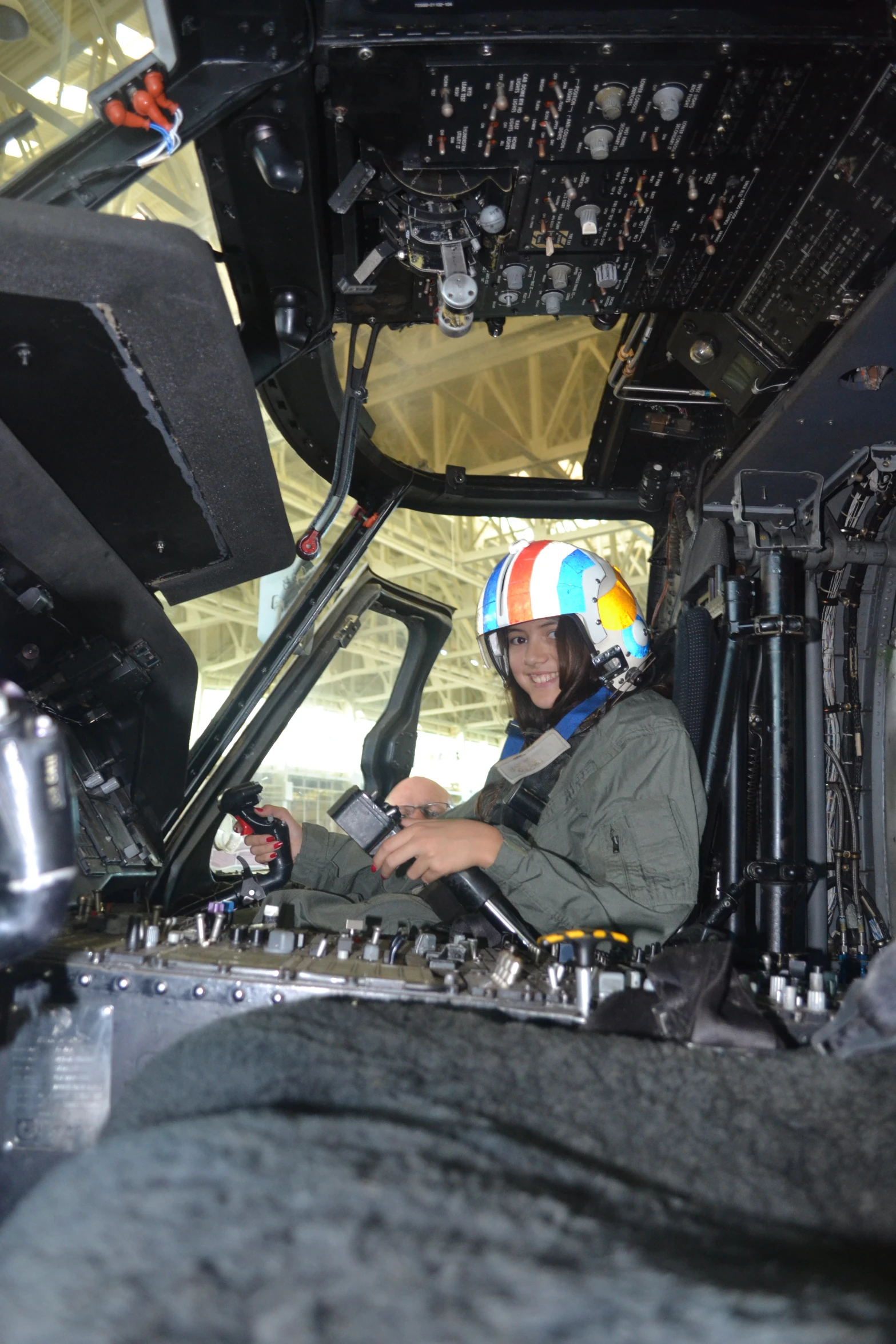 a woman sitting in the cockpit of an airplane