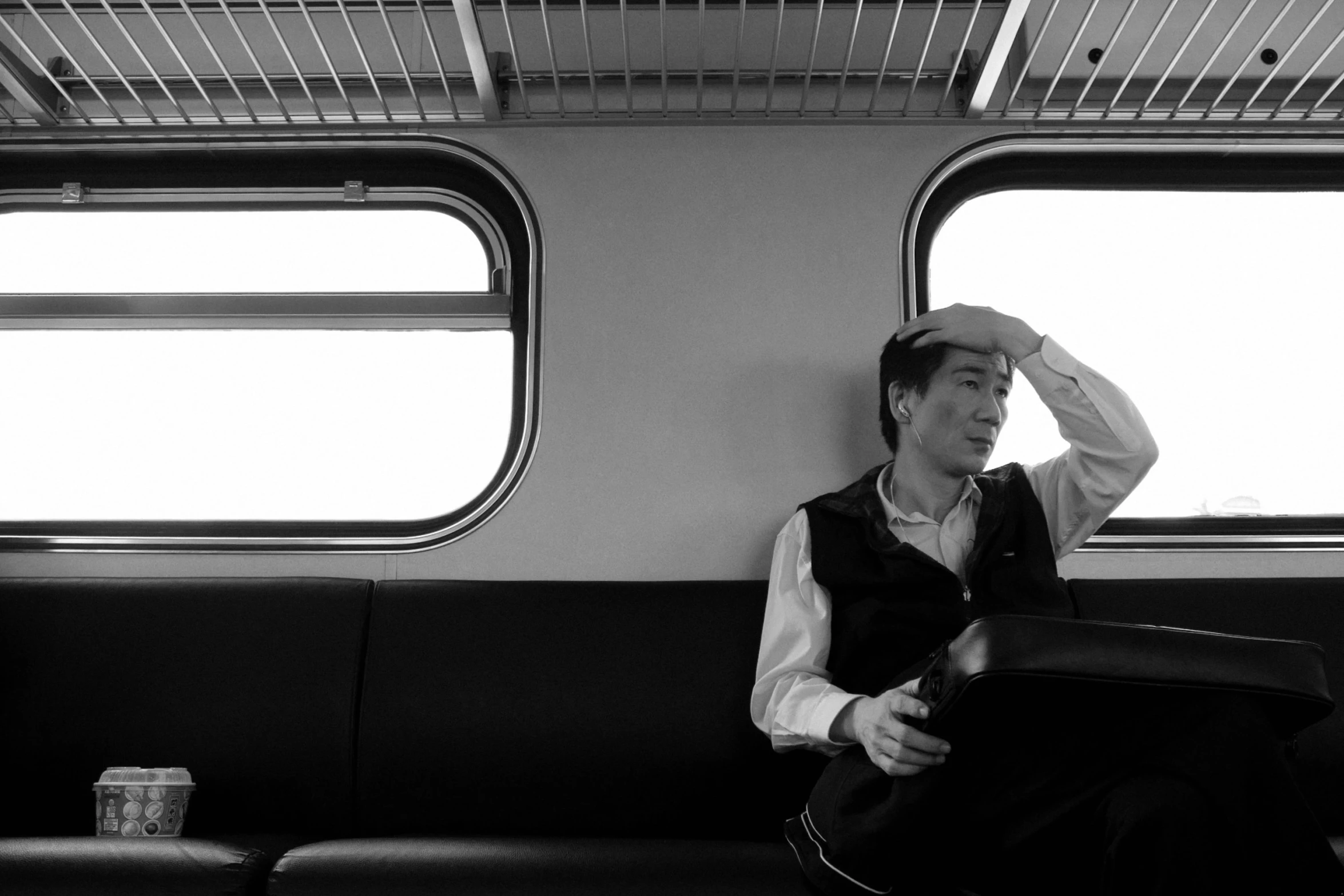 a person wearing a hat sitting on a train