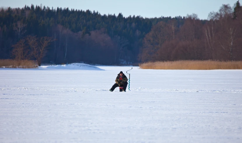 two people are standing in the snow holding a pair of ski poles