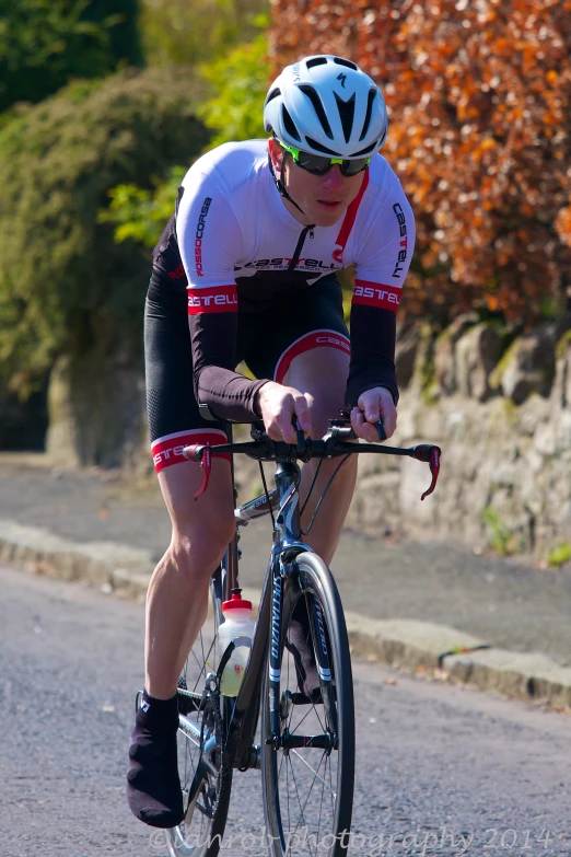 a man riding a bicycle down a street