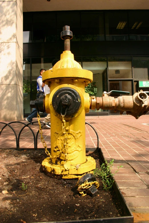 a yellow fire hydrant is shown in front of a building