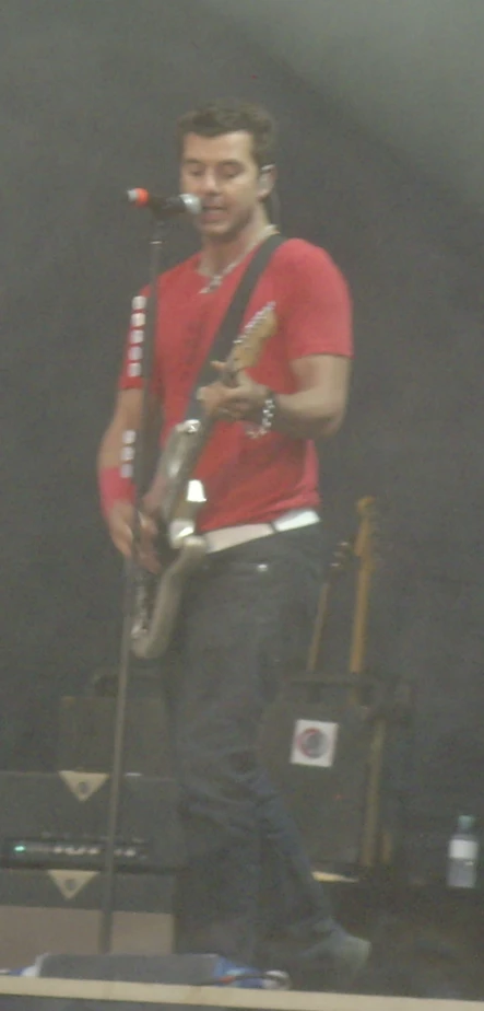 a man on stage singing at a concert