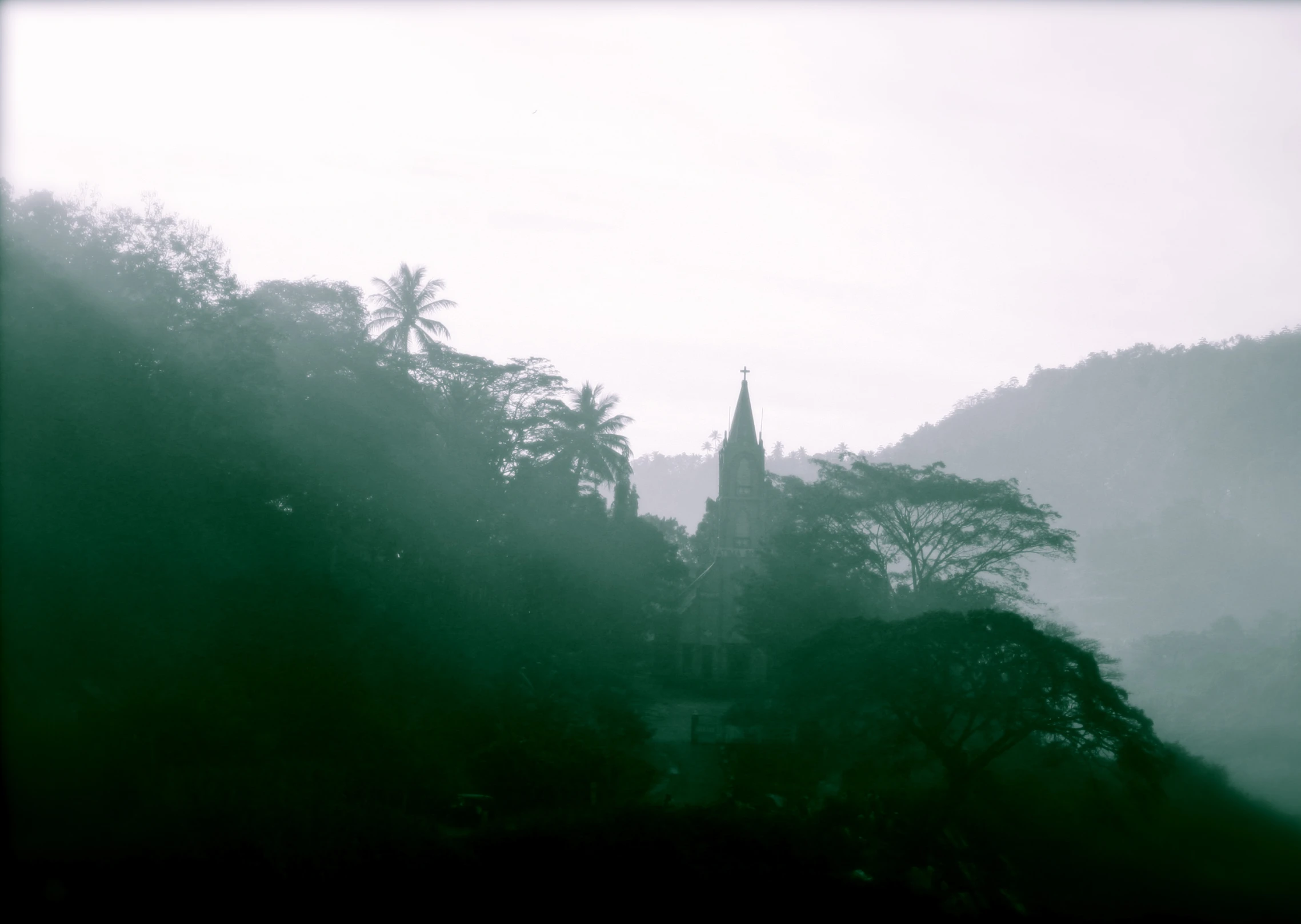 a view from a hillside in the rain