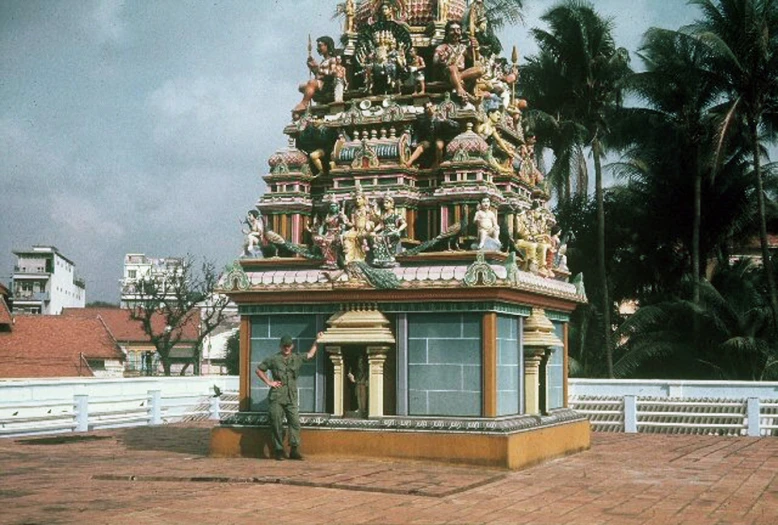 the person is standing near a beautiful ornate structure