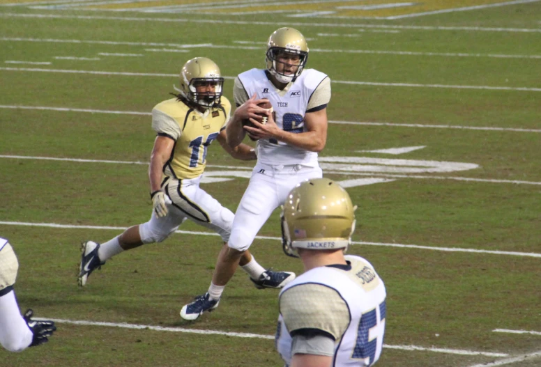 two football players passing the ball during a game