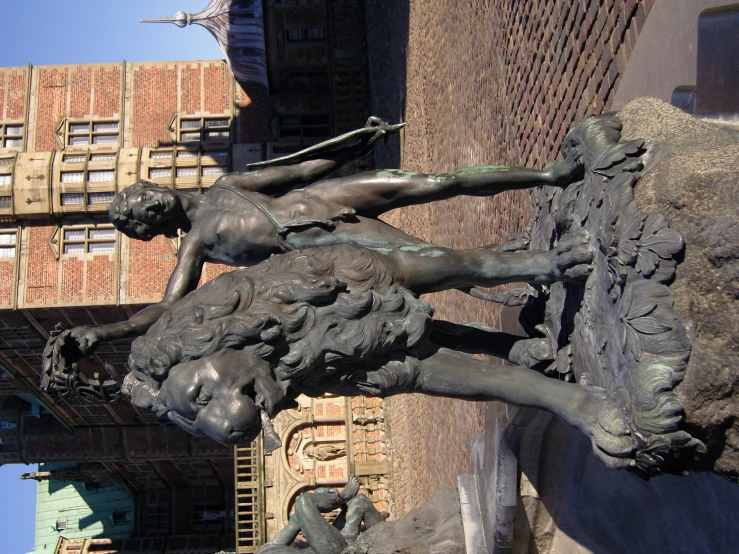 the statue of a man standing next to a stone building