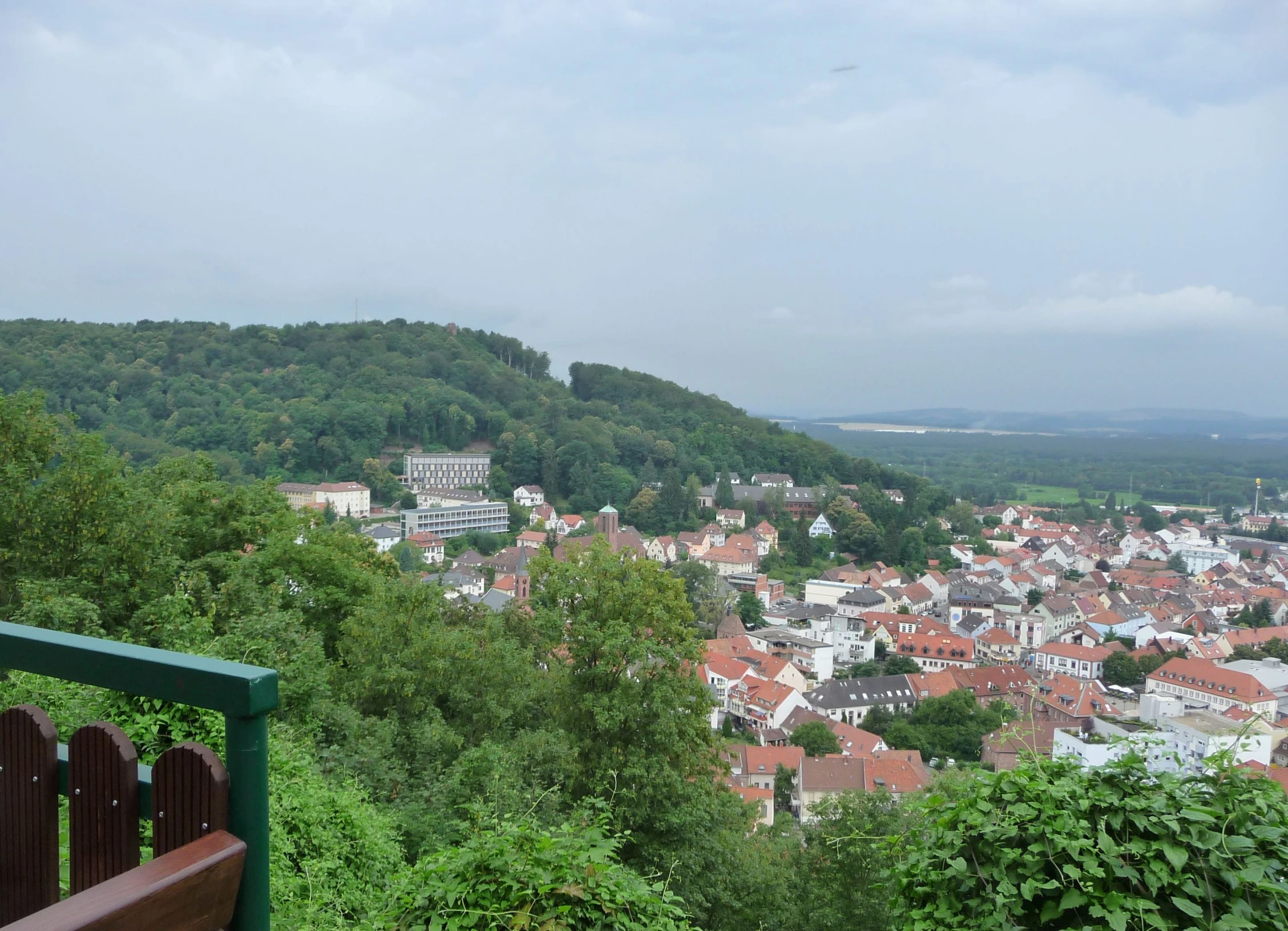 a bench overlooking an urban area in the background