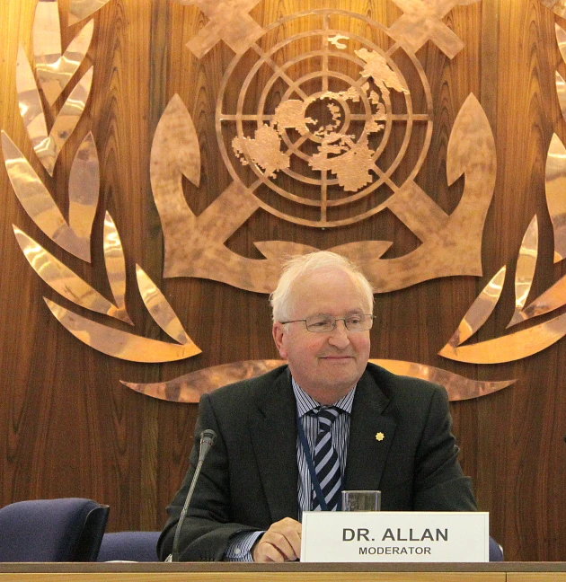 the official speaker is sitting at a table