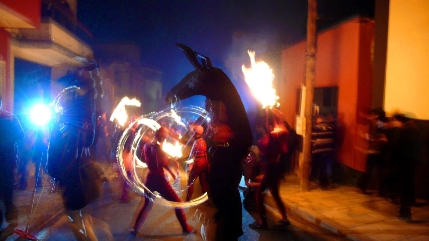 people holding torches and spinning in the air