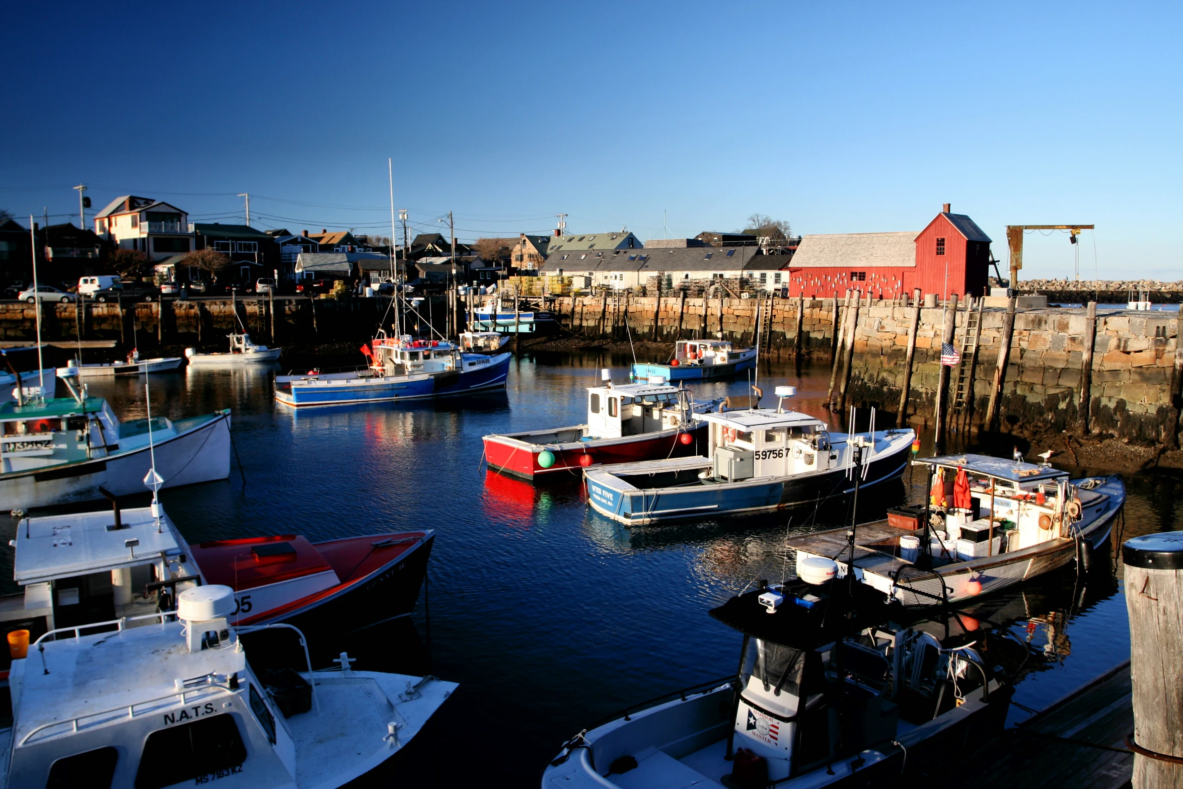 several boats in a harbor on a bright sunny day