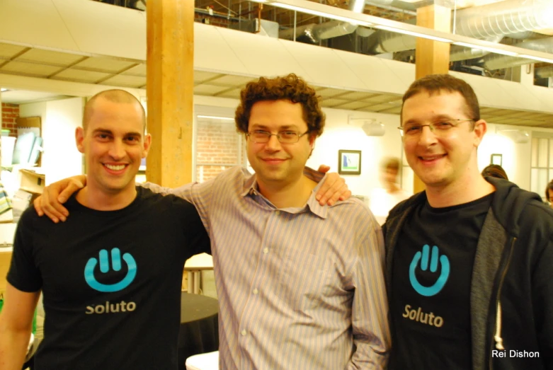 three men wearing black shirts with the word soutuo printed on them