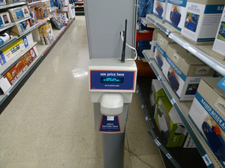 a store with an electronic scaler next to the aisles