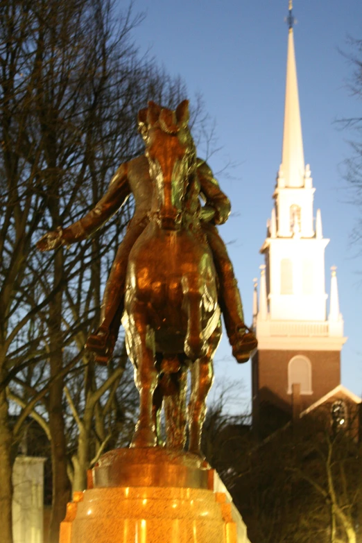 an image of a statue that is by trees