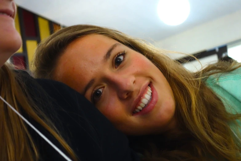 a young lady taking a selfie in her mirror