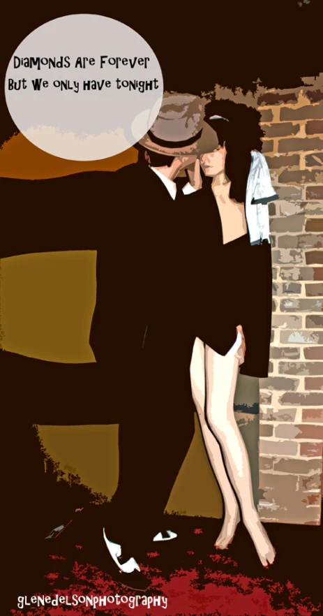 two people stand in front of a brick wall, one person is hugging the other