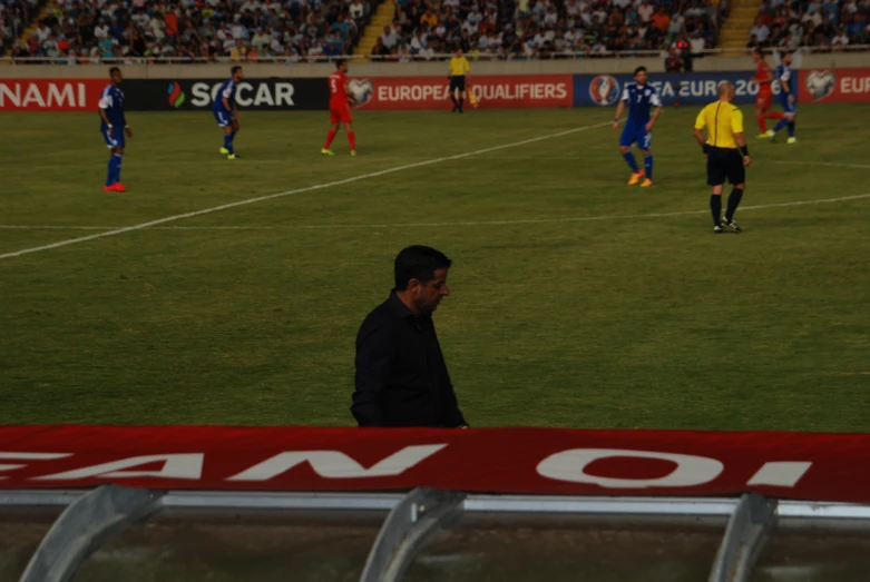 a soccer game is being played on a field with fans watching