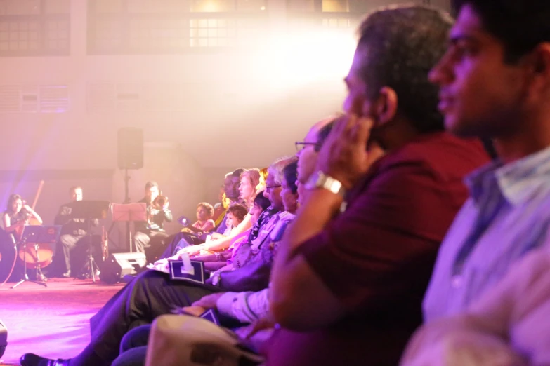 the audience is watching a concert and listening to the band