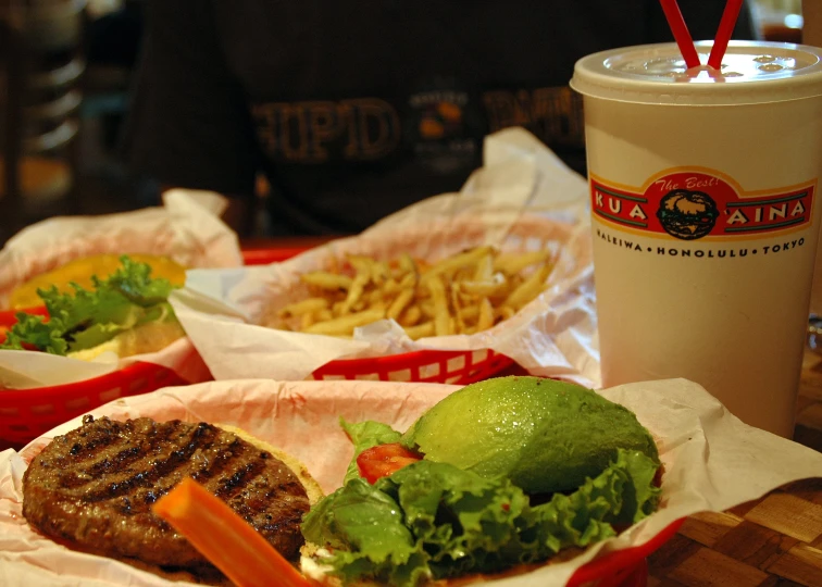 burger with vegetables in basket and side of fries