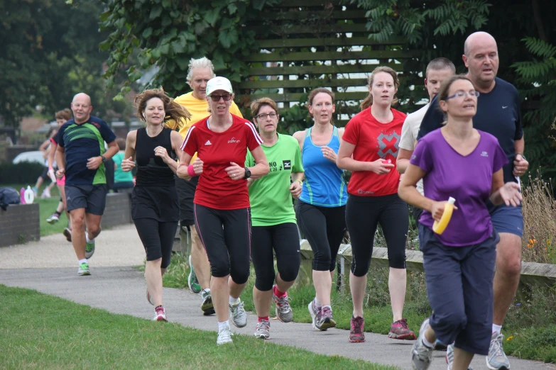 a group of people running down a path together