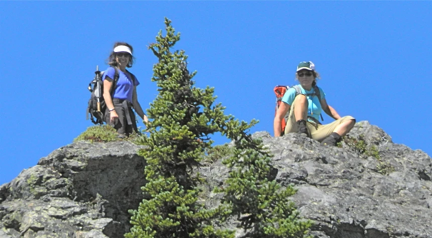 the two hikers sit on the rock formations