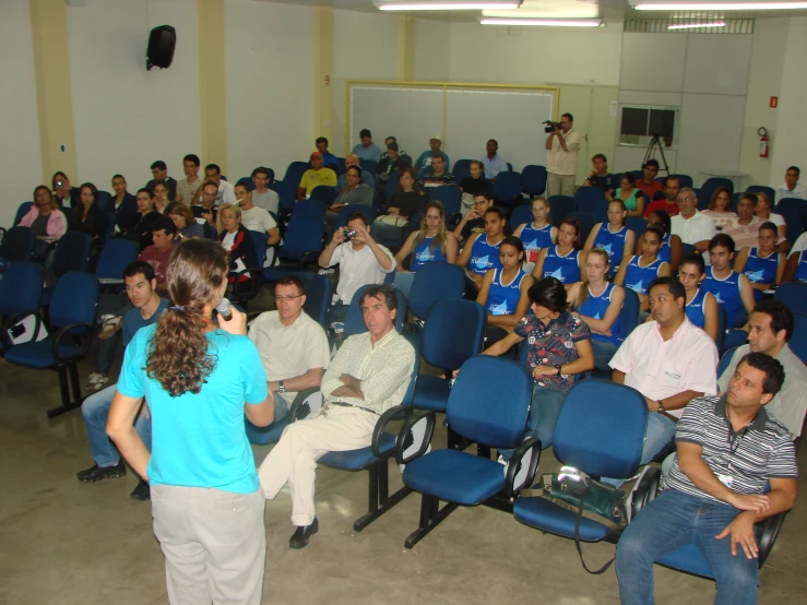 a crowd of people watching a man talk