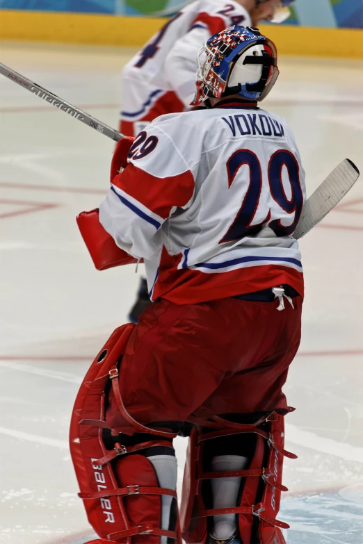 a hockey goalie prepares to warm up for the match