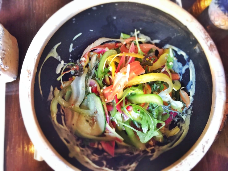 a bowl is full of different vegetables mixed with other foods