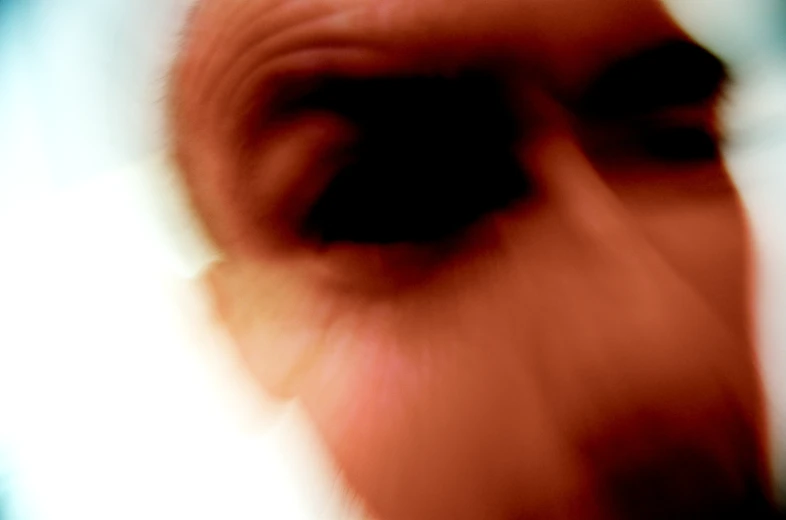 the blurry image shows a man's head looking at soing