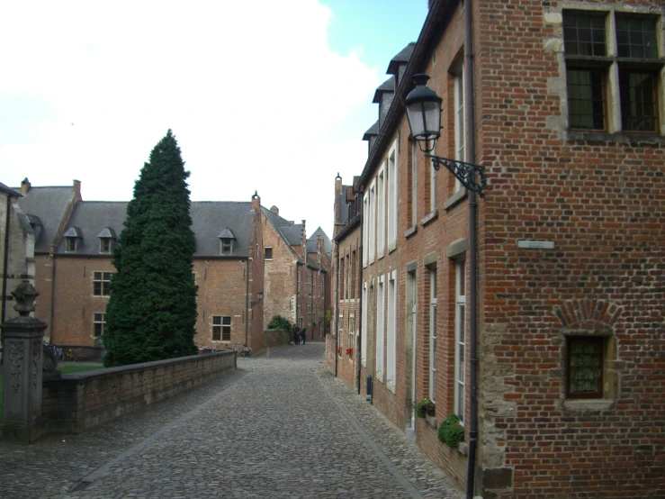 an empty alley lined with brick buildings