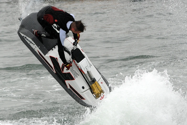 a man holding on to his surfboard riding the waves