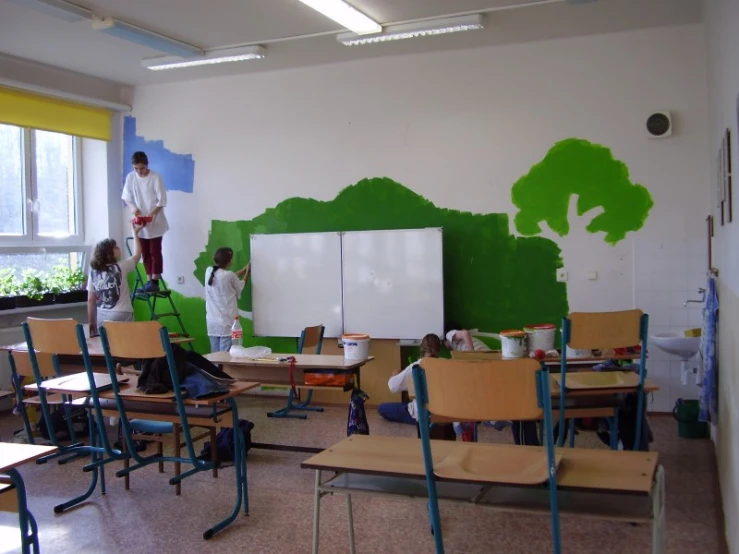 a classroom with three people on top of tables