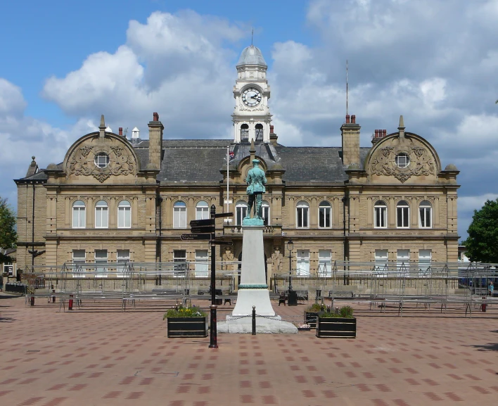 a large building with a clock tower stands against the sky