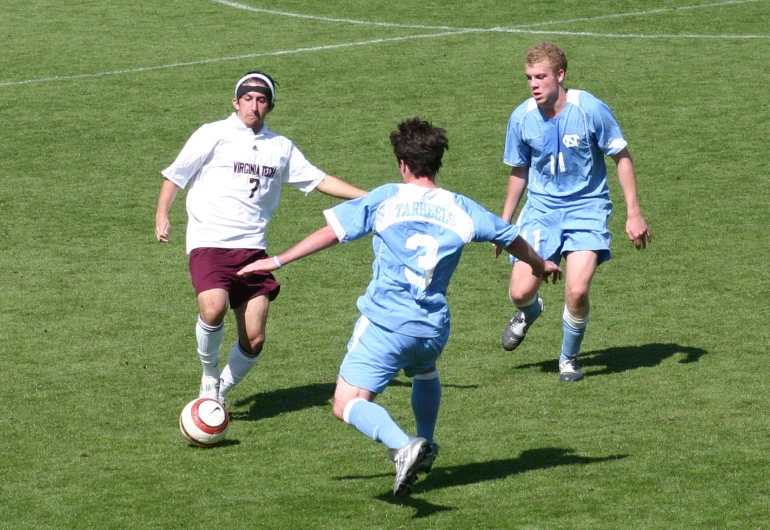 two soccer players are on the field with their ball