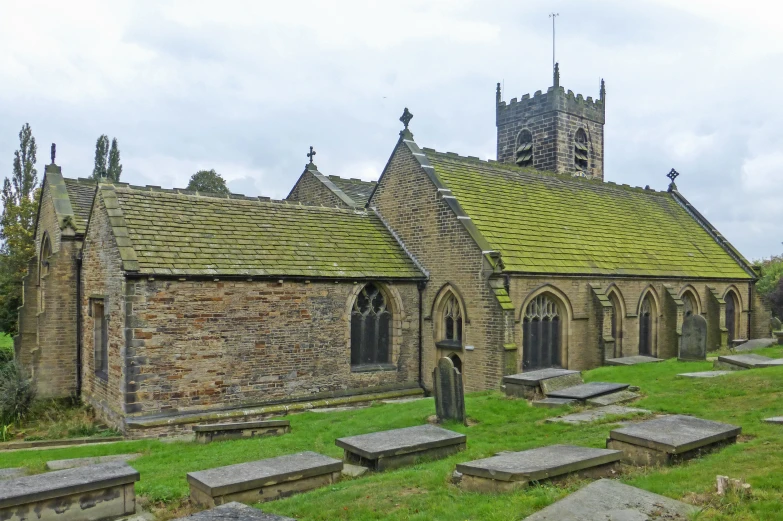 an old church with many tombstones in the foreground