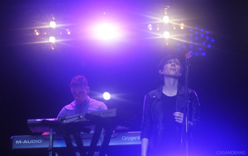 a person standing on a stage with a keyboard