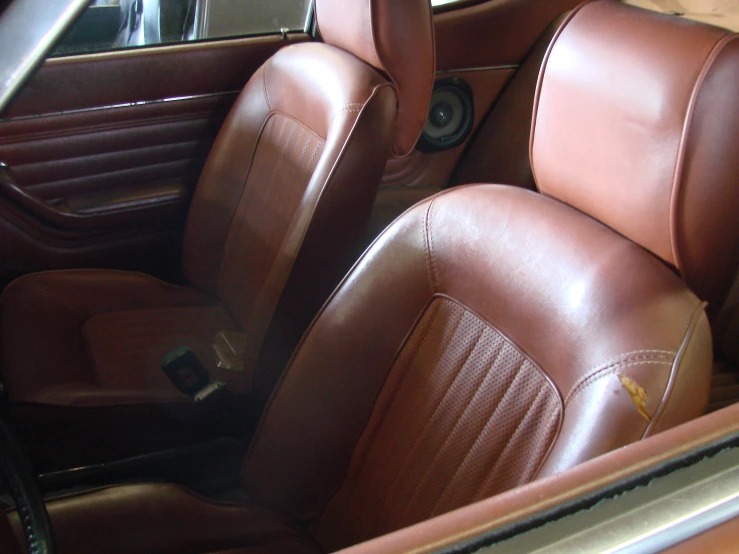 a car seat with some brown leather upholstered