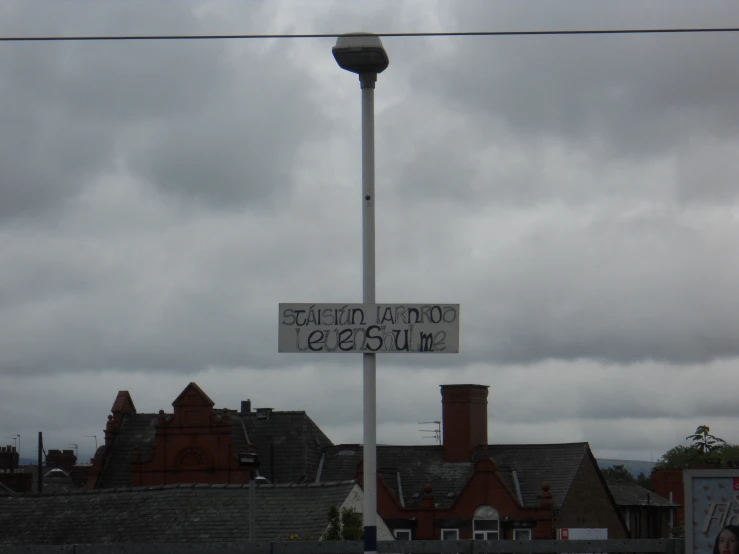 a large street light with two signs on it