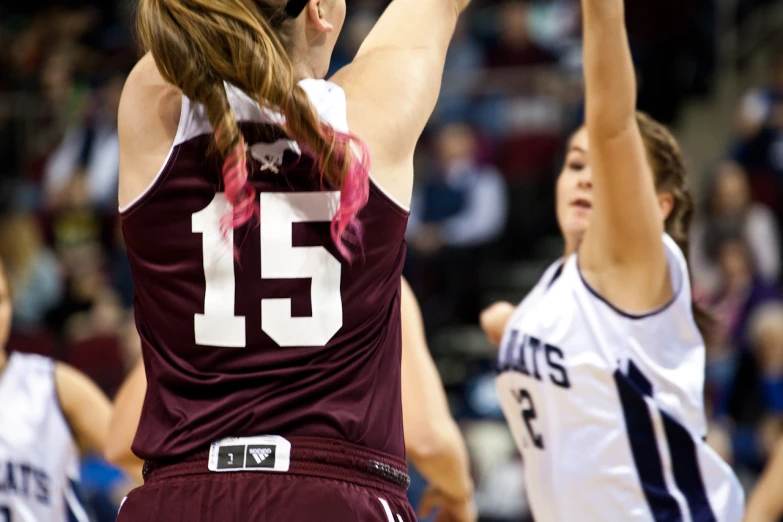 a female basketball player reaching high in the air