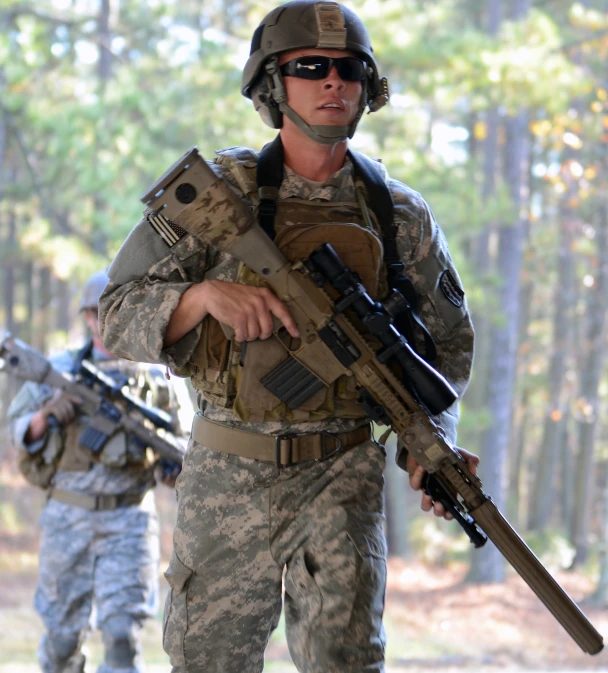 two soldiers dressed in camouflage holding guns