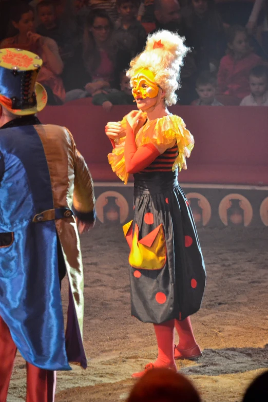 the clowns are talking to one another in front of the audience