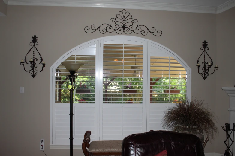 a living room with large windows and a leather chair