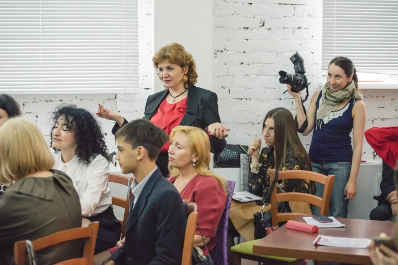 a group of young people sit in a meeting room