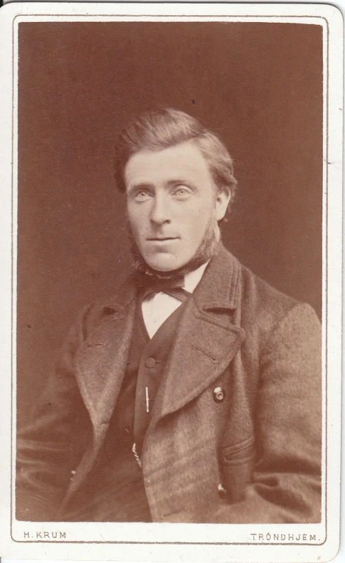 an old pograph of a man with a serious look on his face