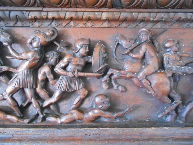 a carved metal wall panel in an old style