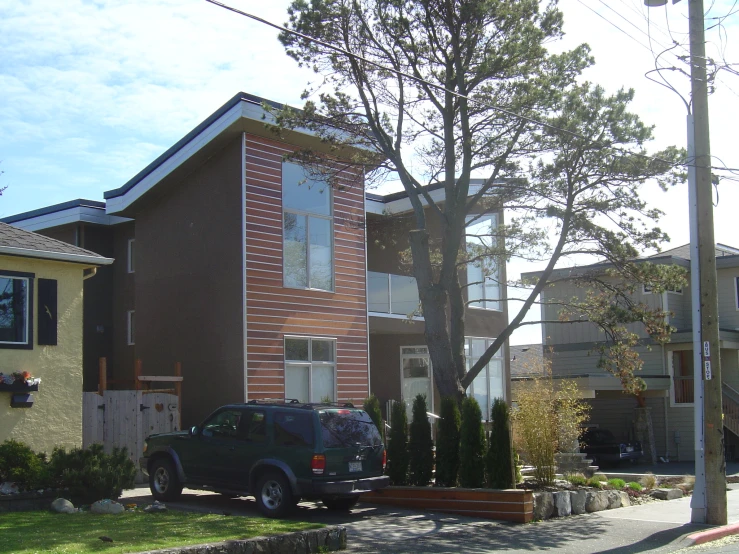 a house with brown brick and white windows