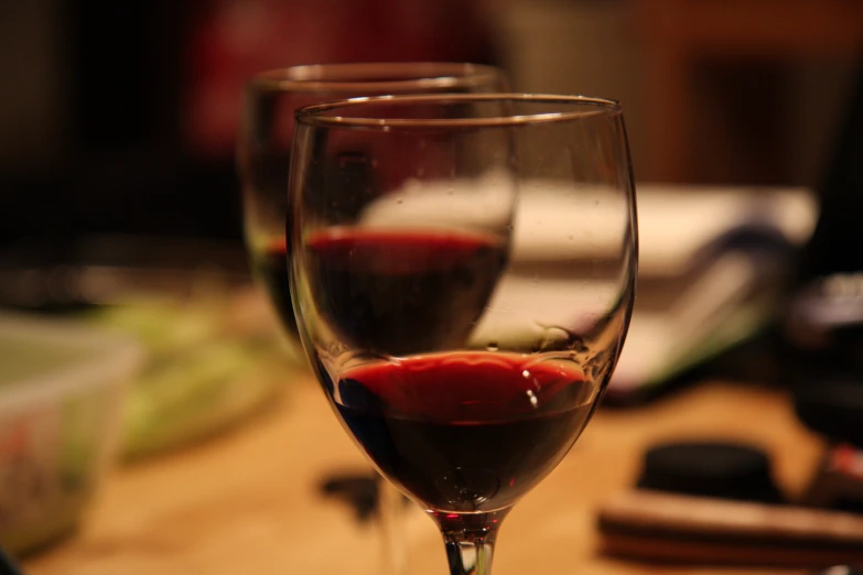 two glasses sitting on top of a table filled with liquid