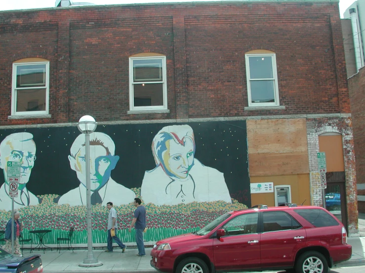 a man is painting a mural on a building