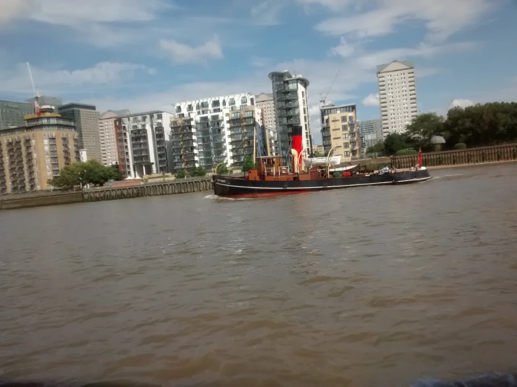 there is a large boat that can be seen sailing down the river